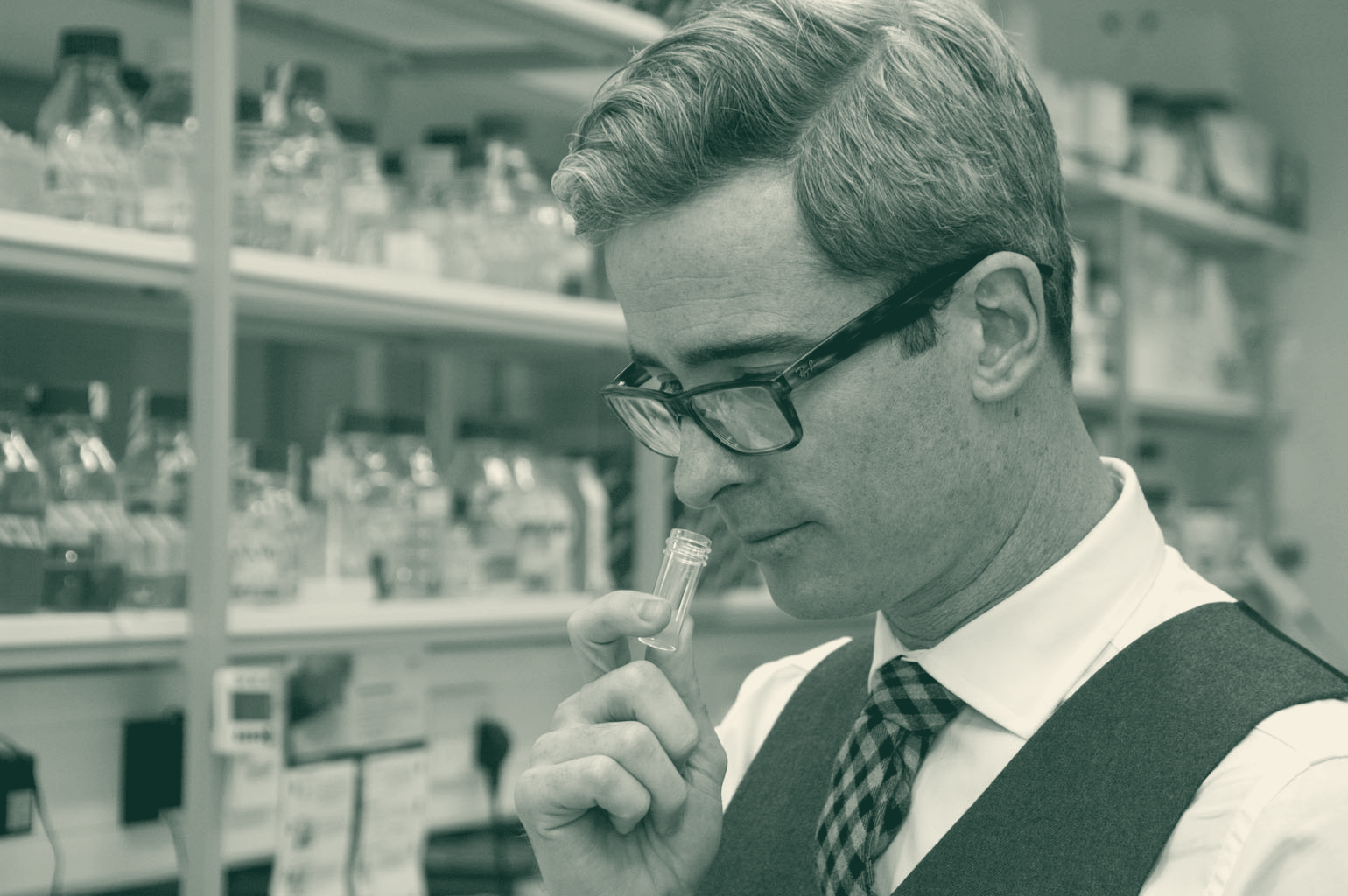 Mr Simon Gane in the lab, examining a sample vial